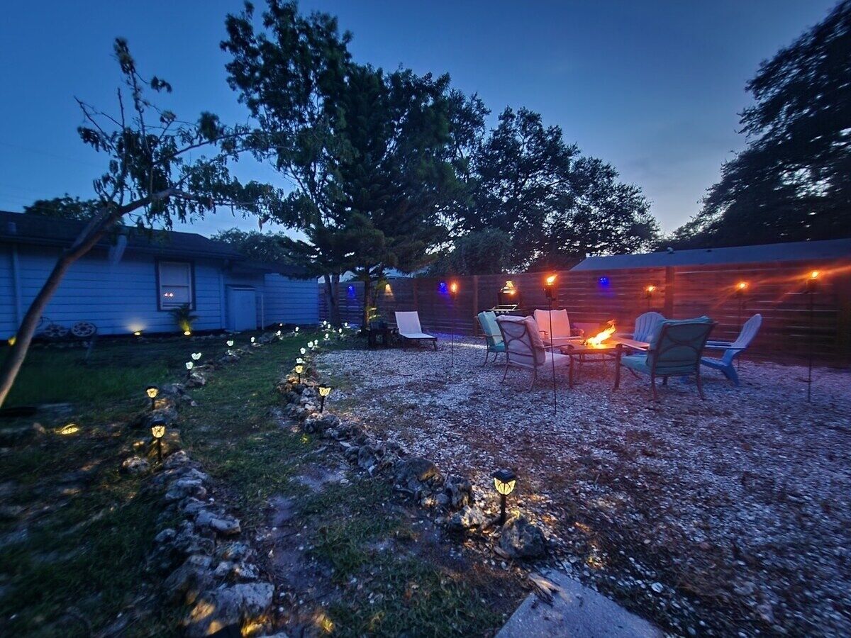 A backyard with a fire pit and outdoor seating.