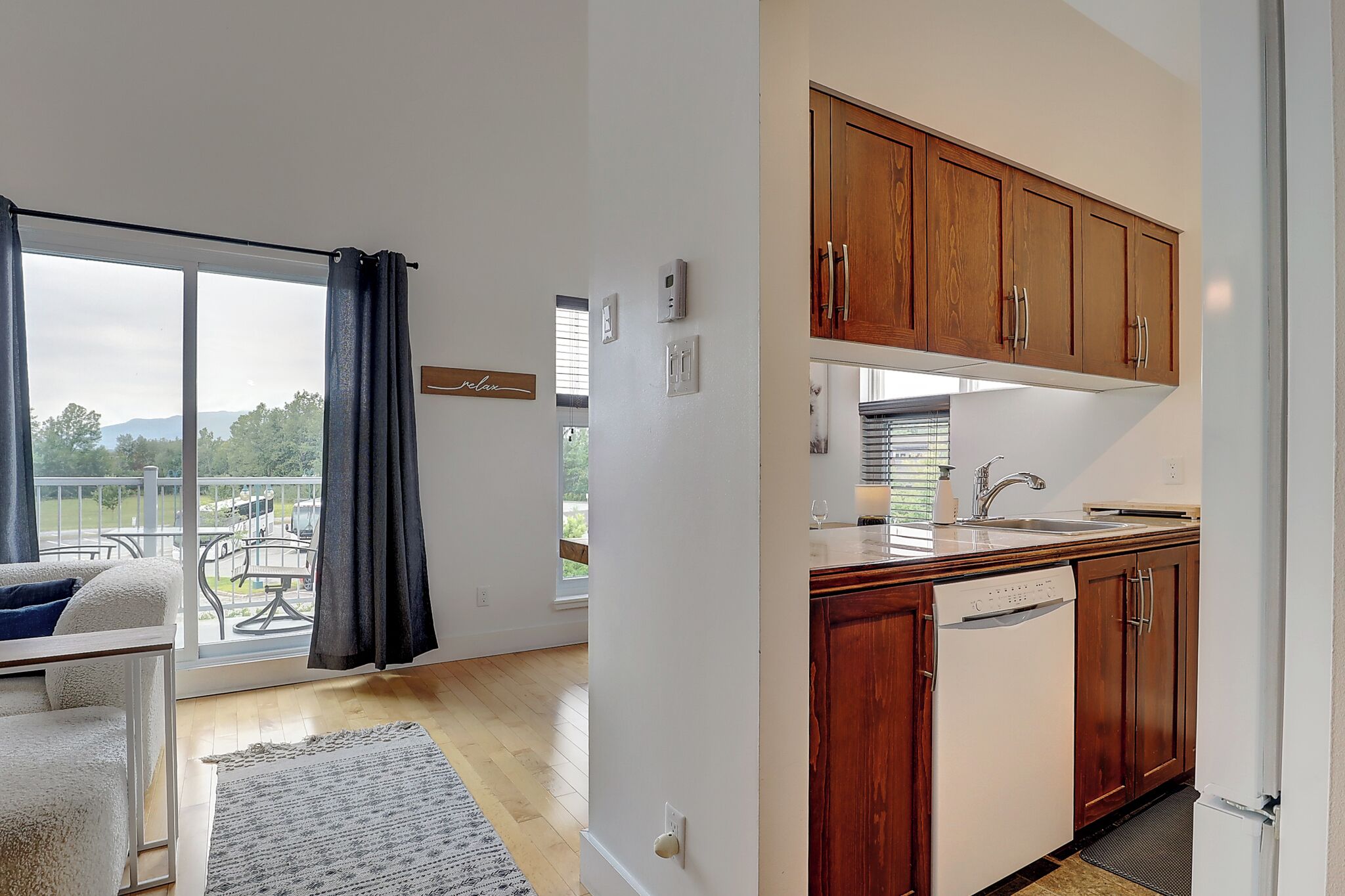 A modern kitchen with wooden cabinets and a built-in dishwasher.