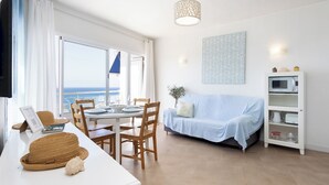 A bright living room with a dining area, a sofa, and a TV. - Home2Book Luminous Seaviews Apt Near The Ocean (Punta del Hidalgo)