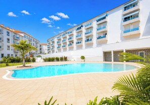 A hotel with a swimming pool, multiple balconies, and a clear blue sky. - Home2Book Relaxing Poolside Escape, Arona (Adeje)