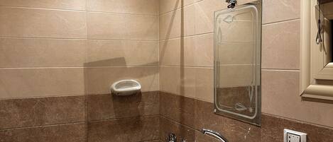 A bathroom with a shower, sink, and toilet.