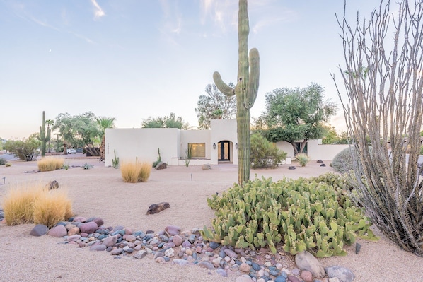 Set amidst a desert landscape, this property offers a serene escape surrounded by cacti and desert flora.