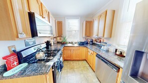 A kitchen with wooden cabinets, a stainless steel refrigerator, a stove, and a sink. - ENTIRE Big Family Home Close To Zoo and Events - Private Patio and Firepit (Pittsburgh)