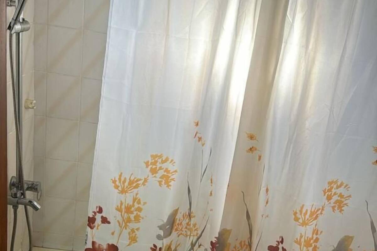 A bathroom with a shower, toilet, and sink.