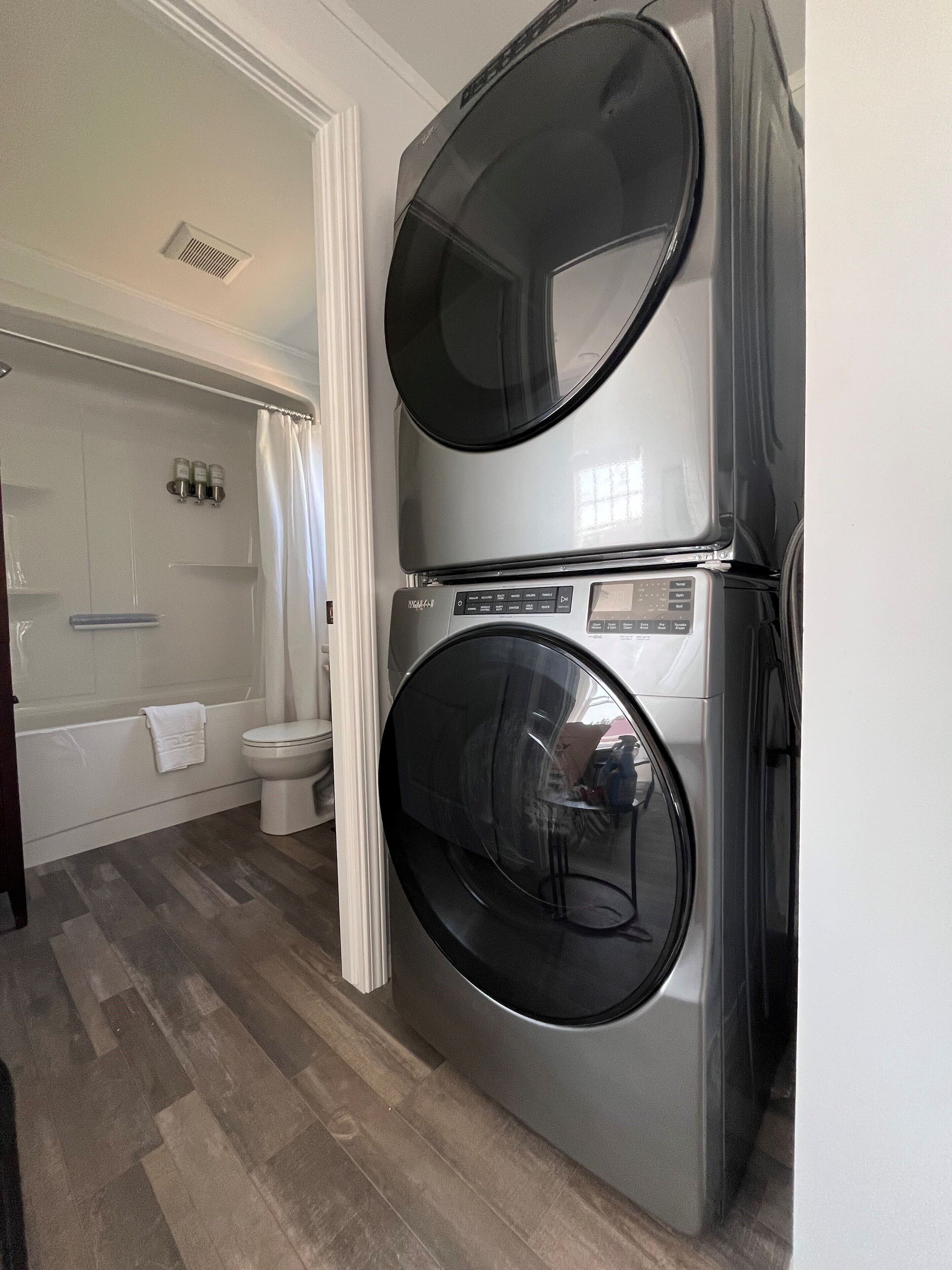 A laundry room with two stacked front-loading washing machines.