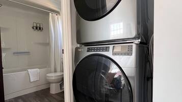 A laundry room with two stacked front-loading washing machines.