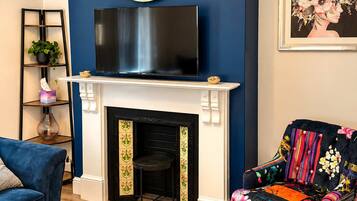 Enjoy a stylish living room featuring a comfortable sofa, a Smart TV, and elegant furnishings. The inviting seating area and thoughtfully arranged décor create a cosy space to unwind, relax, and spend quality time together.