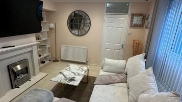 Smart TV, fireplace, books, printers