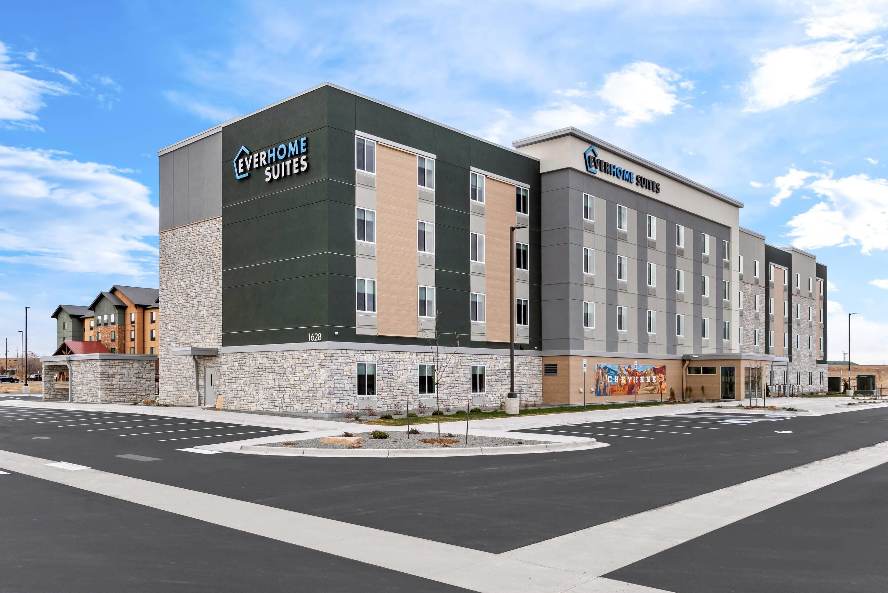 A hotel with a modern design, featuring a stone facade and multiple floors.
