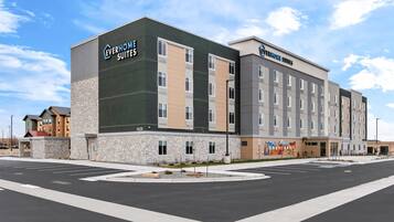 A hotel with a modern design, featuring a stone facade and multiple floors.