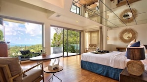 A bedroom with a large bed, a round table, a sofa, and a view of the outdoors. - Villa Skyfall : Spectacular 8 Bedroom Pool Villa with Private Cinema (Koh Samui)
