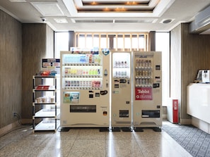A vending machine area with various drink options and a Tabist x The Green Sapporo machine. - Tabist THE GREEN SAPPORO (Sapporo)
