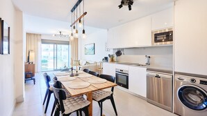 A modern kitchen with a dining area, stainless steel appliances, and a large window. - Apartment 'Bc01 El Sueño Marinsa Beach 2' with Sea View, Wi-Fi and Air Conditioning (El Morche)