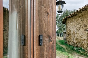 A wooden door with a keypad lock and a lantern.