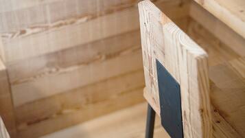 A close-up of a wooden structure with visible grain patterns and a metal bracket.