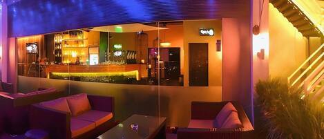 An outdoor bar area with seating and a counter.