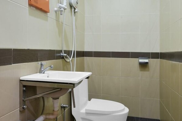 A bathroom with a white sink, toilet, and a towel rack.