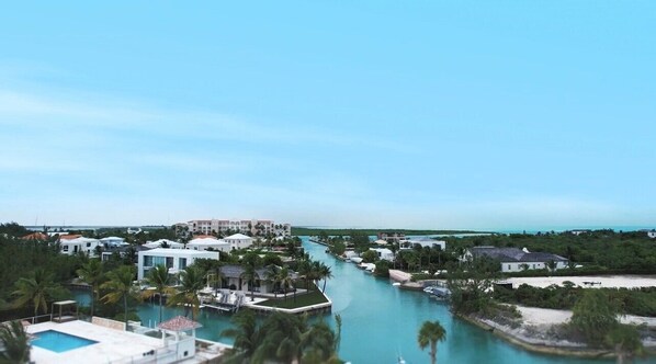 A resort with a marina, multiple buildings, and a clear blue sky.