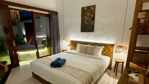 Ein modernes Schlafzimmer mit einem großen Bett, einem Holz-Kopfteil, einem Wandbild und einem kleinen Holztisch mit einem Korb.