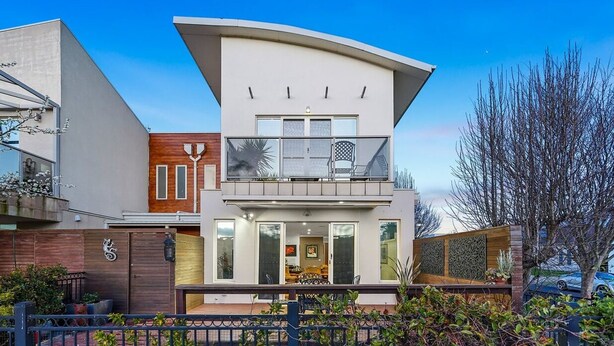 A modern two-story house with a balcony, a wooden fence, and a gate. - StayAU Pakenham Townhouse with Lakeview (Pakenham)