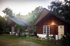 A wooden cabin with a sloped roof, a front door, and a small porch area. - Timba Garden Semporna Free Town / Jetty Transport (Semporna)