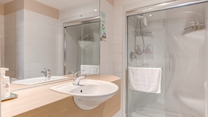 A modern bathroom with two sinks, a glass shower enclosure, and a large mirror. - Double Room #7 (Québec)
