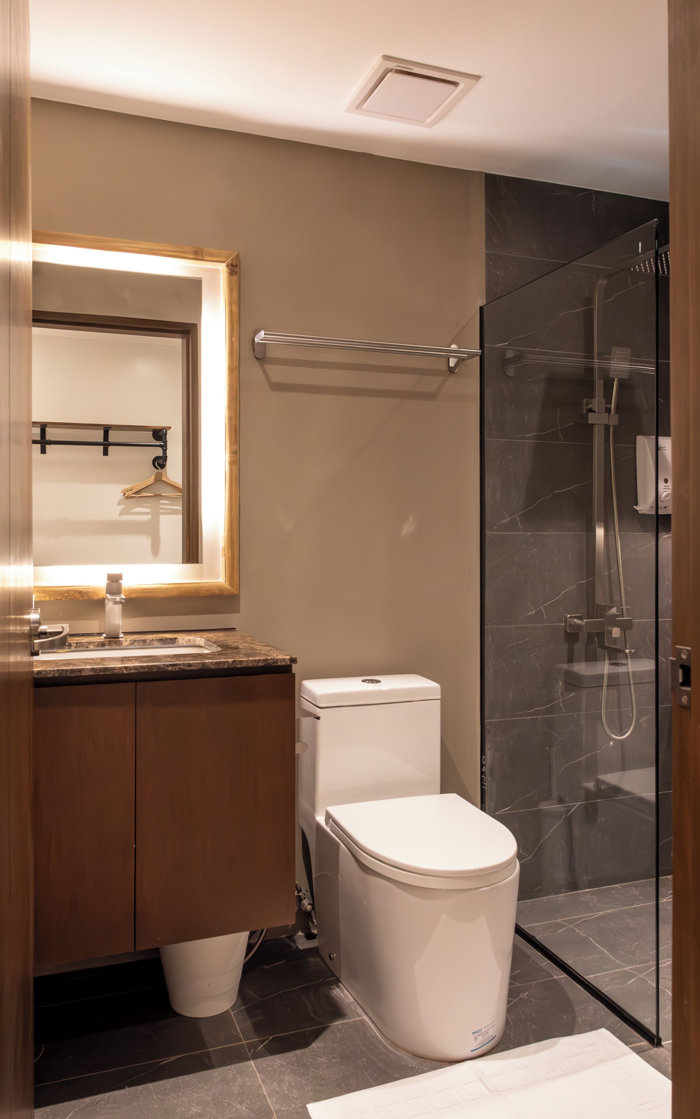 A modern bathroom with a toilet, sink, and shower area.