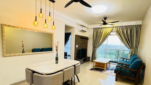 A living room with a dining table, chairs, a sofa, a TV, and a ceiling fan. - KULAI IOI Mall D'Putra Near JPO Senai Airport (Kulai)