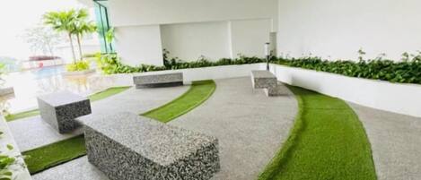 A modern outdoor area with seating and a pathway.