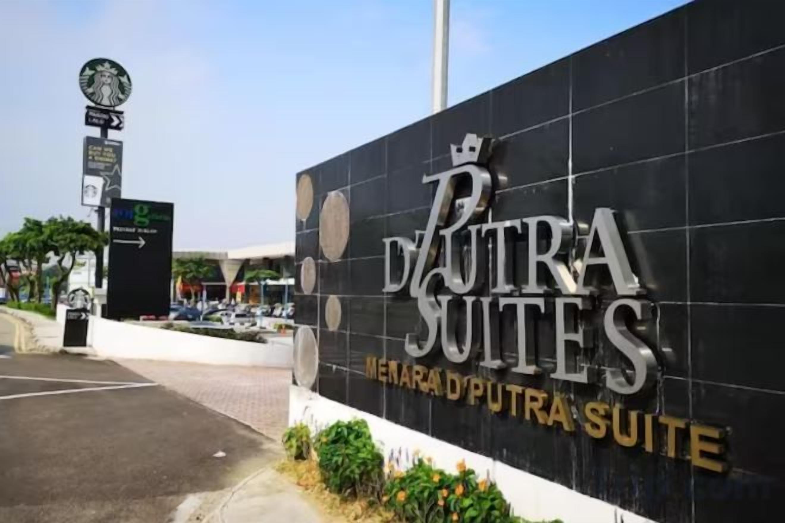 A sign for 'PUTRA SUITES' with a clear view of the hotel name and a directional arrow.