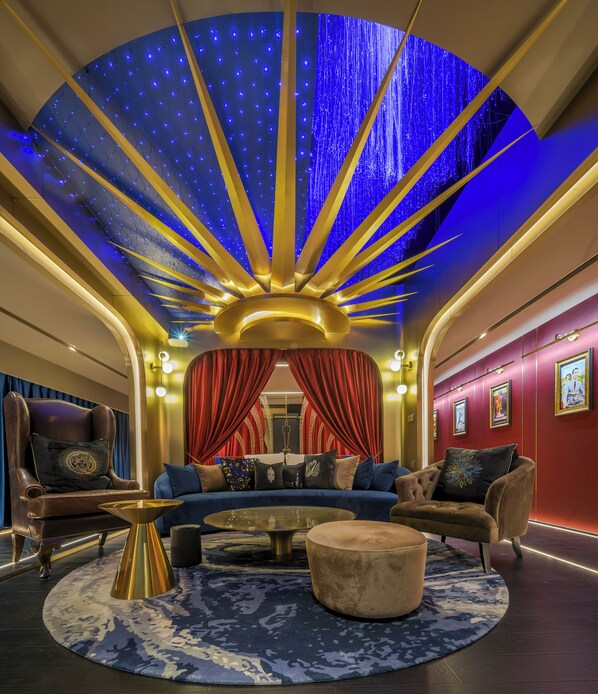 A luxurious lounge with a curved ceiling, plush seating, and a central coffee table. - Movietel Hangzhou (Hangzhou)