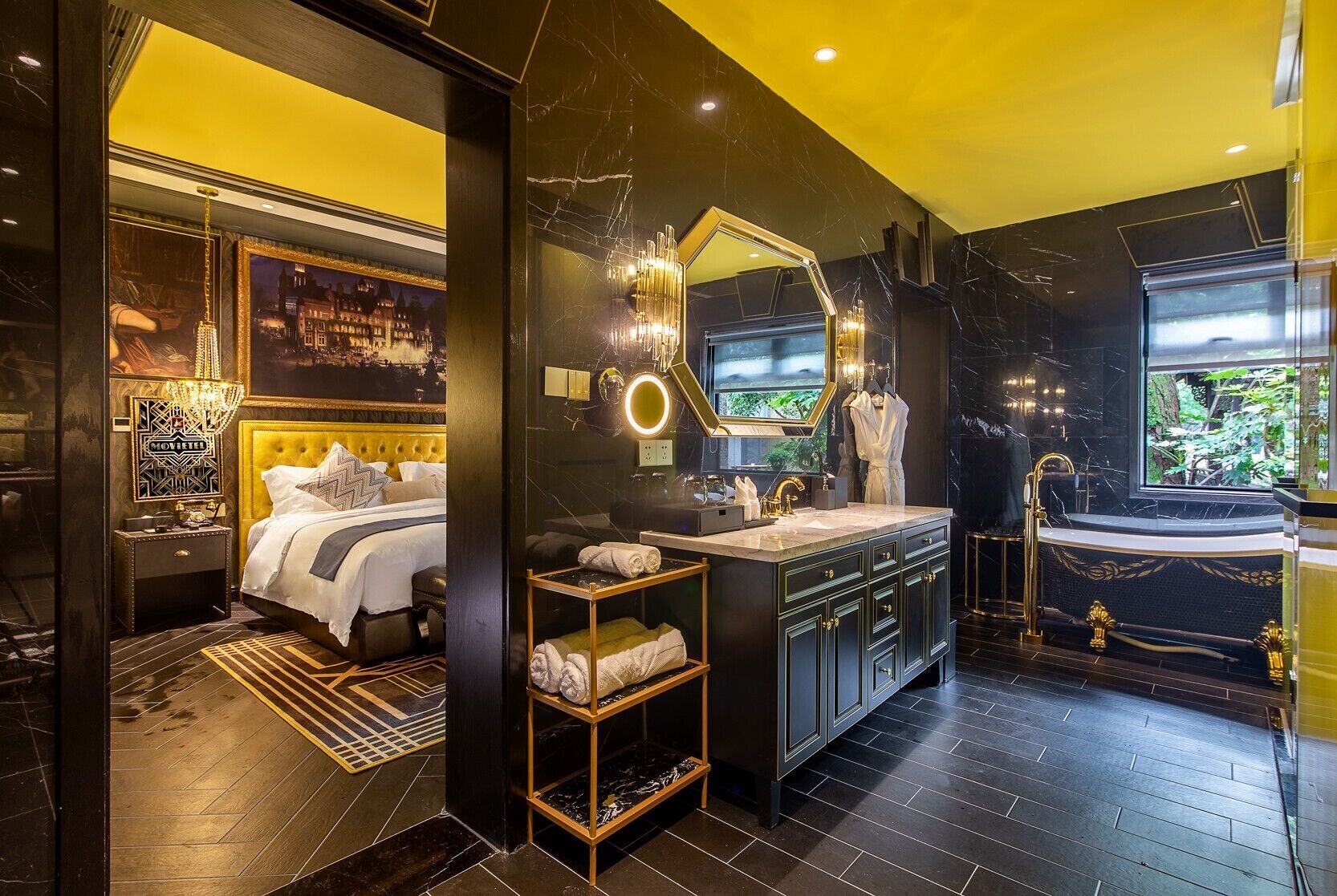A luxurious bathroom with a large mirror, a bathtub, and a vanity with a sink.