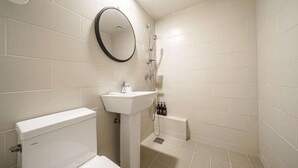 Un baño con inodoro, lavamanos y ducha.