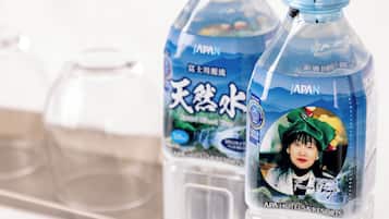Two bottles of water with labels, one with a gold award and the other with a blue label.