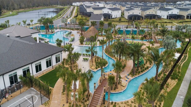 A residential area with multiple houses, a swimming pool, and a basketball court.