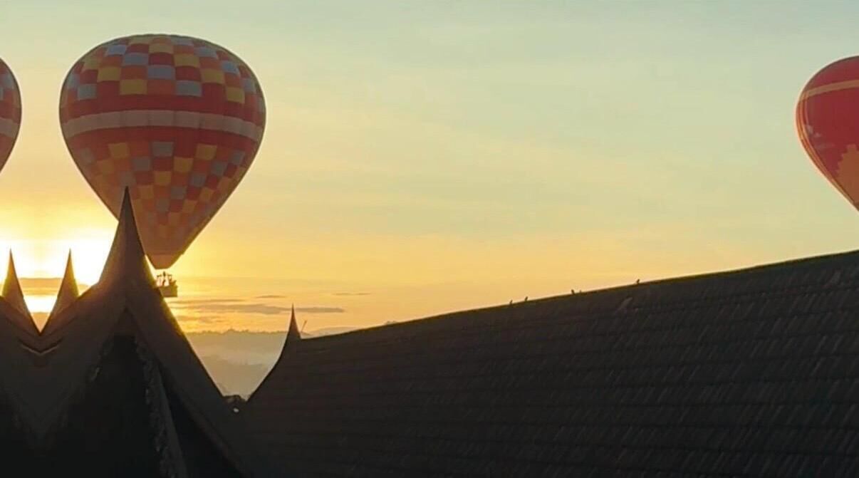 A hot air balloon at sunset with a clear sky.