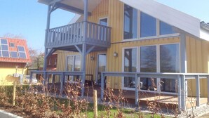 A two-story building with a balcony on the upper floor.
