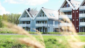 A row of modern, multi-story buildings with balconies, likely part of a hotel or residential complex. - liebevoll eingerichtetes Appartement (Rechlin)