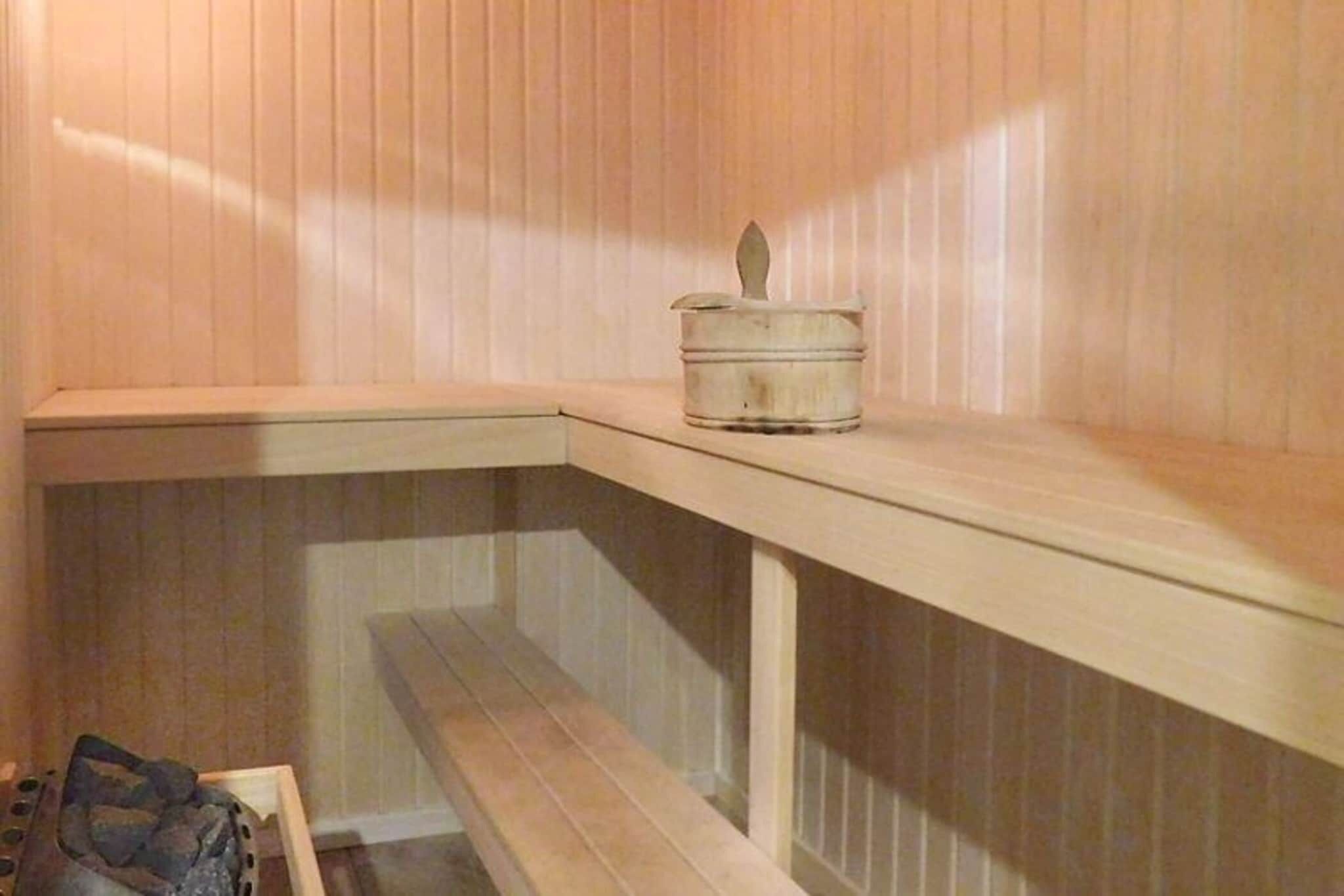 A corner of a room with a wooden bench and a small white container on a shelf.