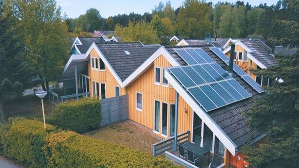 Filas de casas modernas con techos inclinados y paneles solares.