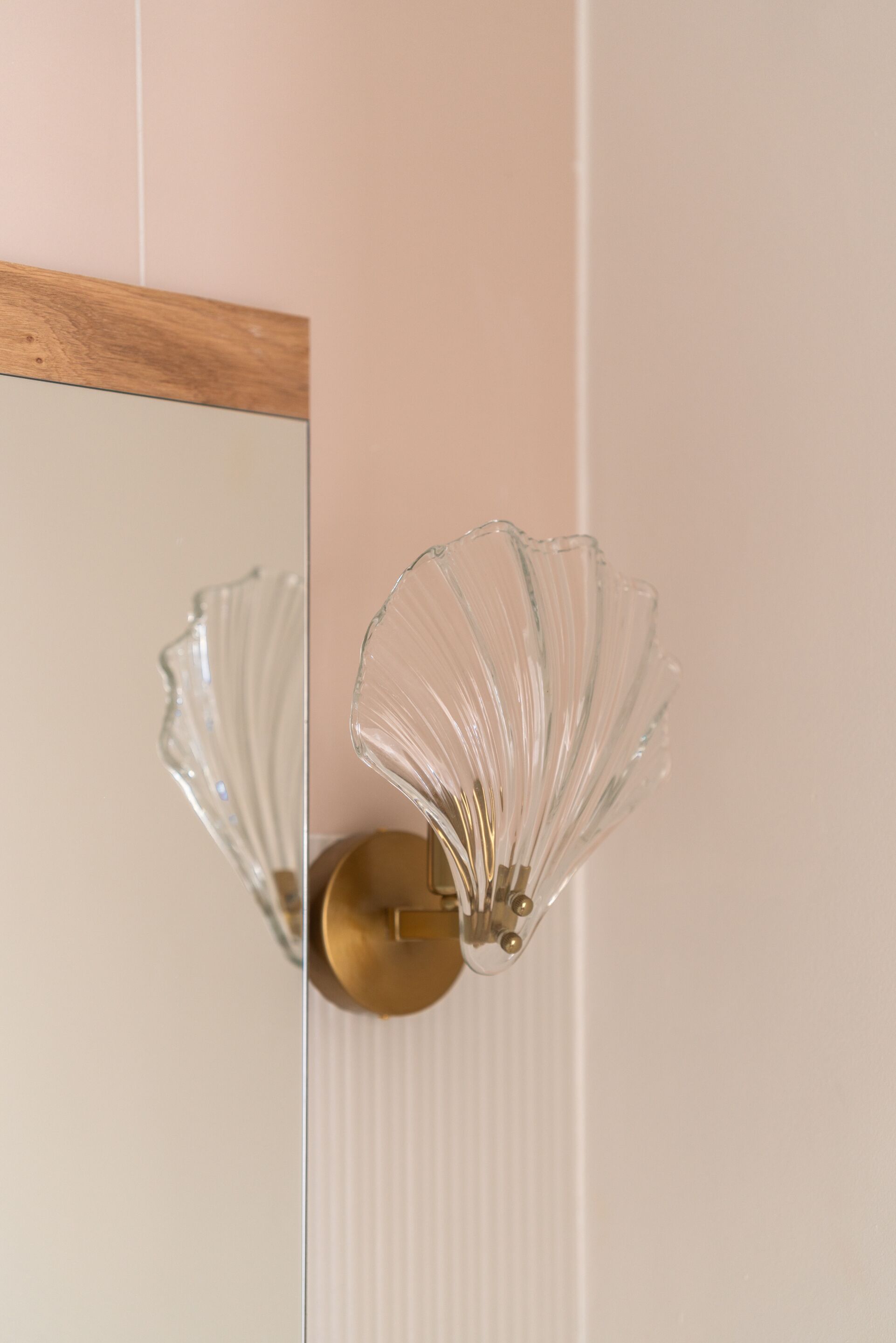 A wall-mounted light fixture with a glass design.