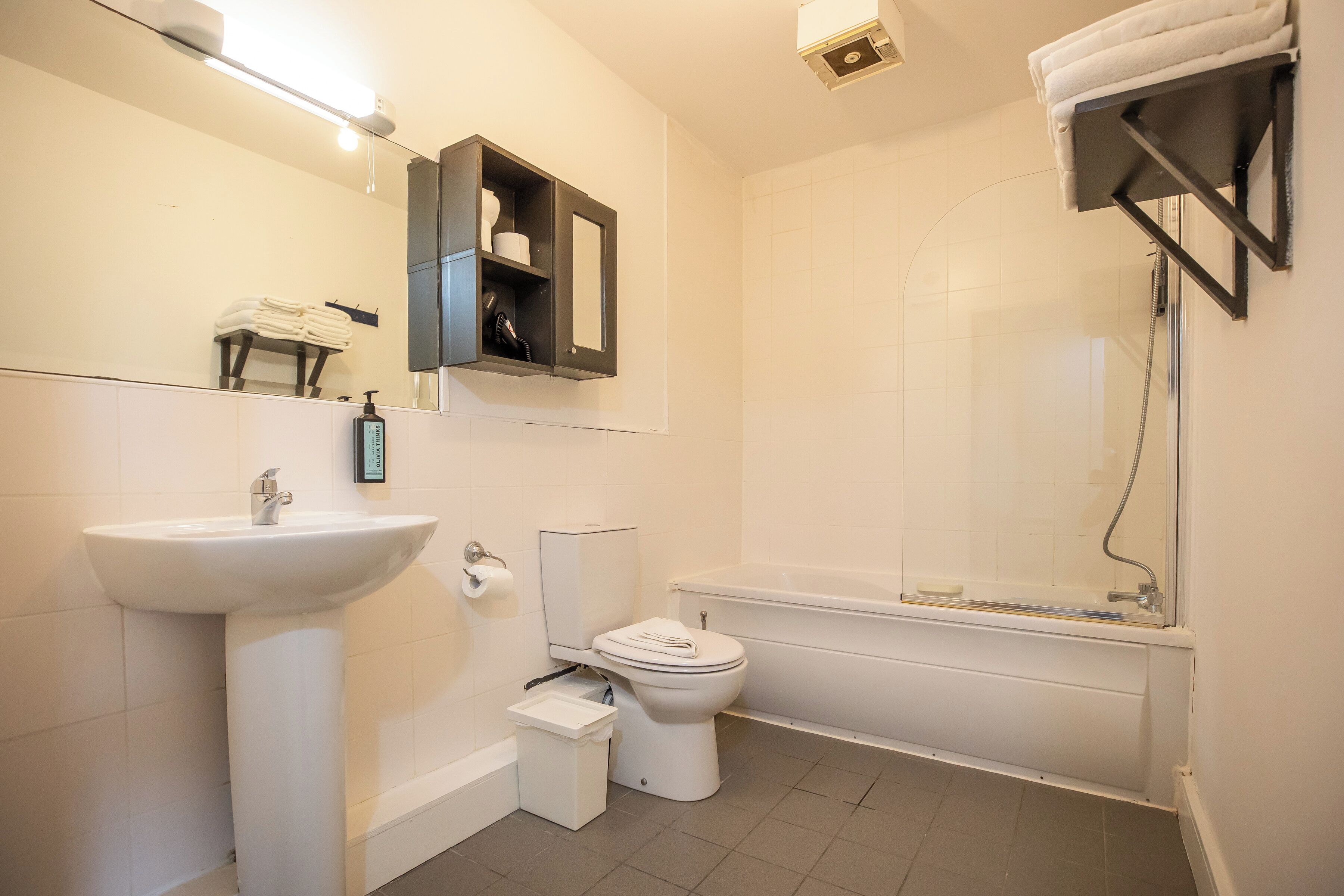 A bathroom with a sink, toilet, and bathtub.