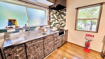 Full-sized fridge, microwave, stovetop, cookware/dishes/utensils