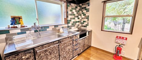 Full-sized fridge, microwave, stovetop, cookware/dishes/utensils