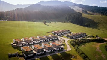 A modern residential complex with multiple buildings featuring flat roofs and a central courtyard.