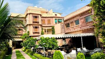 A traditional building with a courtyard, outdoor seating area, and a pathway.