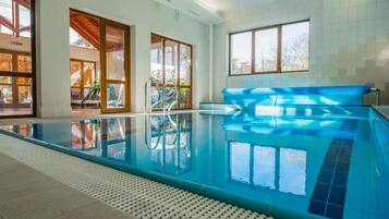 Relax by the pool surrounded by a spacious deck and large windows.