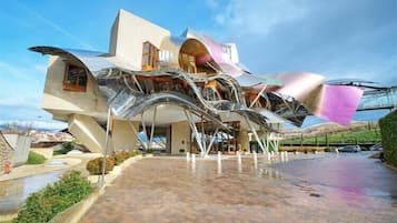 A modern building with a unique architectural design featuring curved and angular elements.