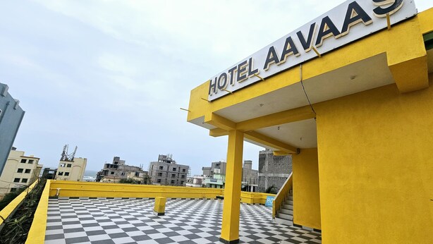 A hotel entrance with a checkered floor and a sign reading "HOTEL AAVAAAS". - HOTEL AVAAS TripandTrip (Puri)