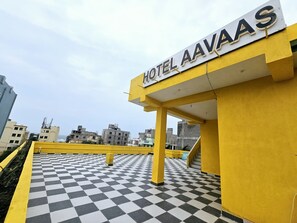 A hotel entrance with a checkered floor and a sign reading "HOTEL AAVAAAS". - HOTEL AVAAS TripandTrip (Puri)